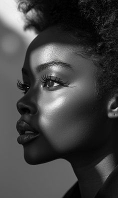 a black and white photo of a woman's face with her hair in an afro