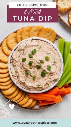 a platter with crackers, carrots and celery on it that says you'll love this easy tuna dip