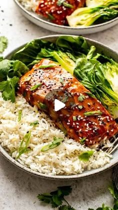 two plates filled with rice, meat and vegetables on top of each other next to a fork