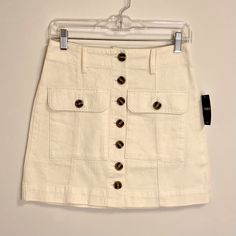 Forever 21 Button Front Mini Skirt With 2 Front Pockets Cream With Brown Buttons Size S 100% Cotton Brand New With Tags Trendy Mini Skirt With Buttons For Work, Fitted Cargo Skirt With Button Closure For Spring, High Waist Skort With Button Closure For Work, High Waist Button Closure Skort For Work, Summer Workwear Mini Skirt With Button Closure, Spring Mini Skirt With Button Closure For Work, Fitted Summer Skirt With Buttoned Pockets, Spring Workwear Skort With Buttons, Trendy Workwear Skirt With Button Closure