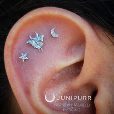 an ear with three small stars and a butterfly on it's side, as well as the wordjunnurrr