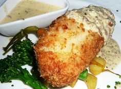 fried chicken with gravy and vegetables on a plate