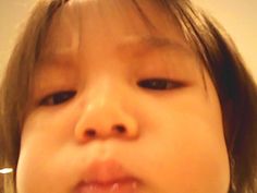 a close up of a child brushing her teeth