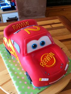 a birthday cake made to look like the character cars from disney pixar is on a table