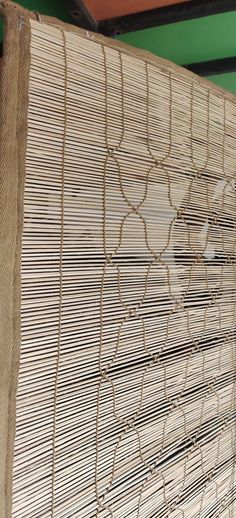 a close up of a bamboo mat with lines and circles drawn on it in front of a green wall