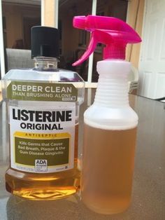 a bottle of listerine is next to a pink sprayer