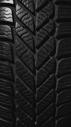 close up view of the tread pattern on a car's tire in black and white