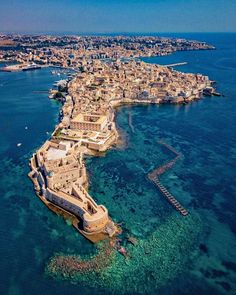 an aerial view of the old city and its surrounding coastline, with clear blue water