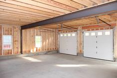 an empty garage with two doors and no windows