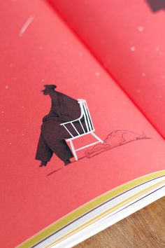 an open book with a drawing of a man sitting in a chair on the cover