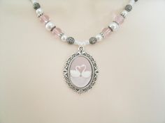 "The swan is the symbol of love and fidelity. This lovely necklace has pink czech glass beads, pearl beads, pewter silver accent beads, seed beads, sterling silver plated bead caps, sterling silver plated filigree beads and a pewter silver pendant with swan cameo. 18\" long. Sterling silver plated toggle clasp." Victorian Necklace, New Plymouth, Nouveau Jewelry, Edwardian Jewelry, Neo Victorian, Art Deco Necklace, Art Nouveau Jewelry, Lovely Necklace, Victorian Jewelry