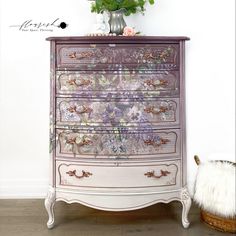 an old dresser with flowers painted on it