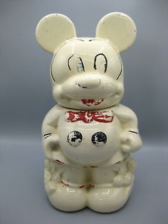 a white mickey mouse figurine sitting on top of a table