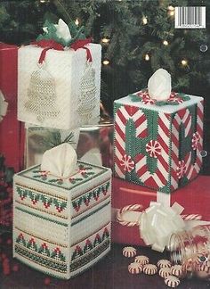 three wrapped presents sitting next to a christmas tree