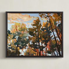 a painting hanging on the wall in front of a white wall with a brown frame