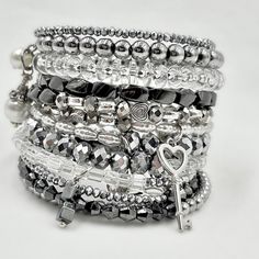 This Stacked Silver Bracelet Is Made On Memory Wire To Wrap Around Your Wrist 11 Times. It Is Strung With Crystals, Czech Beads, Glass Beads, Metal Beads, Hematite, And Finished Perfectly With Multiple Handmade Crystal And Pearl Drops On Each End And 2 Silver Charms: A Key And A Lock. It’s A Perfect Layered Look Filled With Crystals And Bling. Silver Bracelet Stack, Crystal Wrap, Lock It, Memory Wire Bracelet, Hematite Bracelet, Memory Wire Bracelets, Bracelet Cuff, Wire Bracelet, Memory Wire