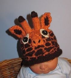 a baby wearing a knitted giraffe hat