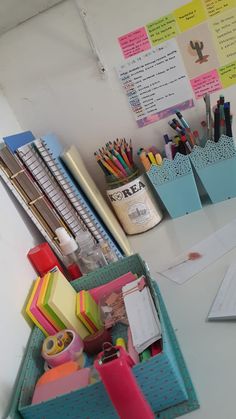 the desk is cluttered with pens, pencils and other office supplies