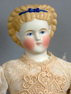 an old doll with blonde hair and blue eyes