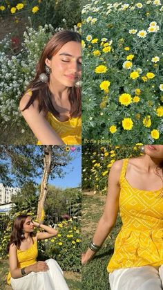 a woman sitting on the ground in front of flowers wearing a yellow top and white pants