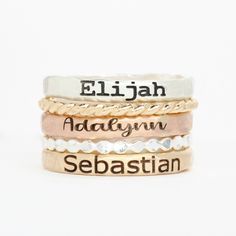 Set of 5 stacking rings. Made with .925 sterling silver, 14K gold filled, or 14K rose gold filled. Engraved rings are approximately 2.5mm wide. Comes with 3 hammered name rings, 1 twist band, and 1 dot band. Please message me if you would like a different font. These rings are made of high quality materials. The colors will not chip off or fade and can be worn in water. This ring is made to order in your size. If you don't see your size available please feel free to message me. All orders ship i Dainty Stacked Rings As A Gift, Dainty Engraved Stackable Rose Gold Ring, Stacked 14k Gold Rings For Gift, Dainty Rose Gold Stackable Engraved Ring, Dainty Rose Gold Engraved Stackable Ring, Stacked 14k Gold Rings As Gift, Stacked Rings In 14k Gold As Gift, Stackable Rose Gold Sterling Silver Midi Rings, Personalized Gold Midi Rings In Sterling Silver