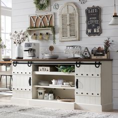 a white kitchen with lots of decor on the wall