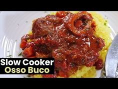 slow cooker osso buco on a white plate with a fork and spoon