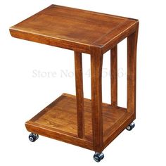 a small wooden table with wheels on the bottom and one shelf attached to the side