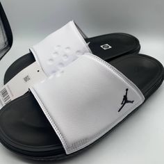 Air Jordan Play Slide White/Black Sandals Casual White Slip-on Sport Sandals, White Synthetic Open Toe Sport Sandals, White Closed Toe Casual Flip Flops, Casual White Closed Toe Flip Flops, White Non-slip Casual Sport Sandals, Casual White Non-slip Sport Sandals, White Leather Flip Flops With Textured Footbed, White Closed Toe Sport Sandals With Cushioned Footbed, White Synthetic Sandals With Removable Insole