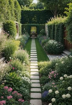 a garden with lots of plants and flowers on the side of it, along with stone walkway