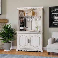 a white cabinet sitting next to a couch in a living room