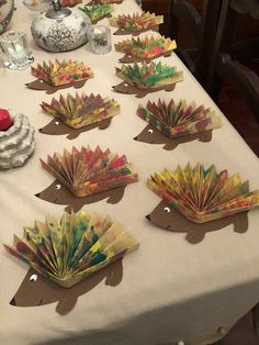 several folded paper hedges sitting on top of a table