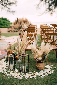 an outdoor ceremony set up with chairs and flowers