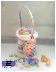 a crocheted basket filled with lots of candy