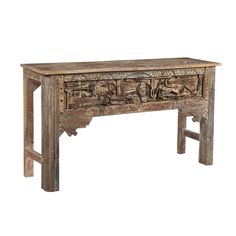 an old wooden table with carvings on it