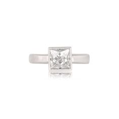 a white gold ring with a princess cut diamond