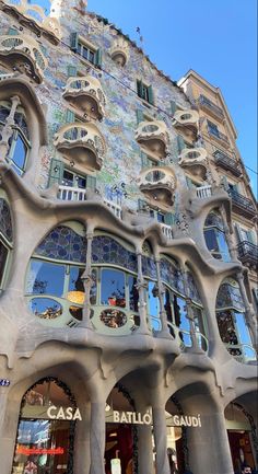 the facade of a building with many windows and balconies on it's sides