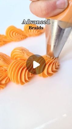 someone using a knife to cut orange spirals on a white surface with the words advanced braids