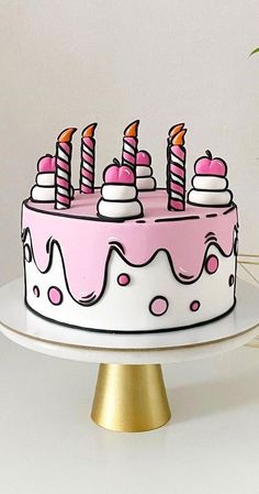 a birthday cake with pink frosting and candles