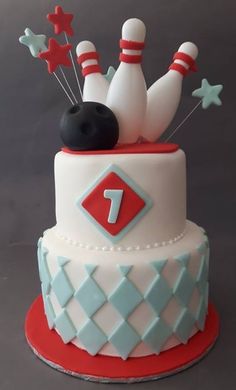 a cake decorated with bowling pins and balls