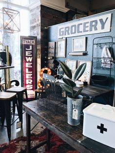 a room filled with lots of different types of furniture and decor on top of a wooden table