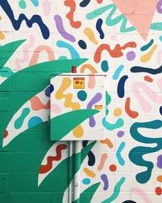 a colorful wall painted with different colors and shapes