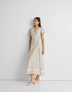 Unveil elegance with our 'Maxi Wrap Dress in Blue Florals,' featuring a relaxed fit and adorned with delicate blooms. This chic wrap dress, perfect for cool evenings or leisurely afternoons, offers both style and comfort. Embrace its versatile design, complemented by the convenience of pockets on both sides. Elevate your summer wardrobe with this trendy maxi dress, ideal for casual gatherings or a stylish day out. Wash in cold water or dry clean only Do not soak bleach or wring Line dry in shade Elegant Wrap Dress With Floral Print And Surplice Neckline, Elegant Floral Wrap Dress With Surplice Neckline, Elegant Floral Print Wrap Dress, Elegant Floral Print Midi Wrap Dress, Elegant Floral Midi Wrap Dress, Elegant Floral Print Wrap Maxi Dress, Elegant Floral Print Wrap Dress For Garden Party, Elegant Flowy Floral Dress For Daywear, Spring Silk Wrap Dress, Maxi Length