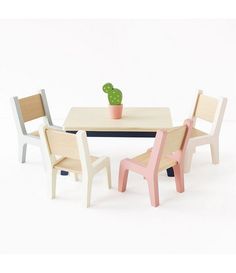 three chairs and a table with a cactus in the middle