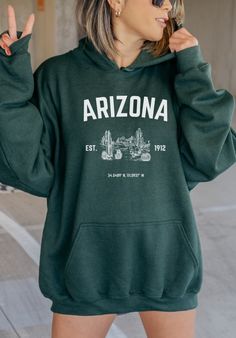 Arizona Hoodie/ Vintage Arizona Hoodie/ State Hoodie/ Arizona Sweatshirt/ Arizona Gifts tip: size up if you want more of an oversized look! ~Processing and Shipping~ * Each item is made to order, taking 2-7 days to complete. If you are ordering multiple items, please note they may not always ship together. Tracking information will be provided when it is available. * If there are any problems with your order, PLEASE contact us through Etsy Messages before leaving a review. We value our customers Cozy College Hoodie Sweatshirt, Cozy Hooded College Sweatshirt, Cozy Hooded College Hoodie, Casual Oversized Hoodie For Outdoor Activities, Relaxed Fit Hoodie For Fall Urban Adventures, Urban Hoodie With Letter Print For Outdoors, Cozy Letter Print Hoodie Sweatshirt, Fall College Hoodie With Kangaroo Pocket, College Fall Hoodie With Kangaroo Pocket