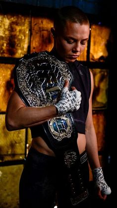 a man holding a wrestling belt in his hands