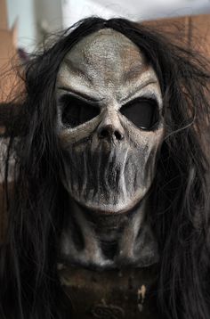 a creepy looking mask with long hair on it