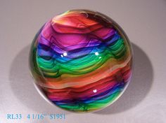 a colorful glass ball sitting on top of a table