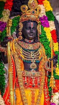 an idol is displayed in front of flowers