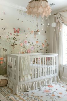 a baby's room with a crib and floral wallpaper on the walls